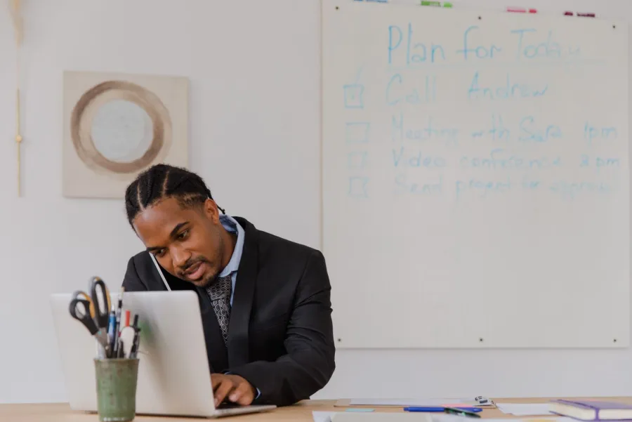 Business owner reviewing local listings on a laptop and phone